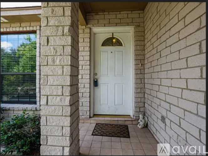 A white door is on the right side of a brick wall.