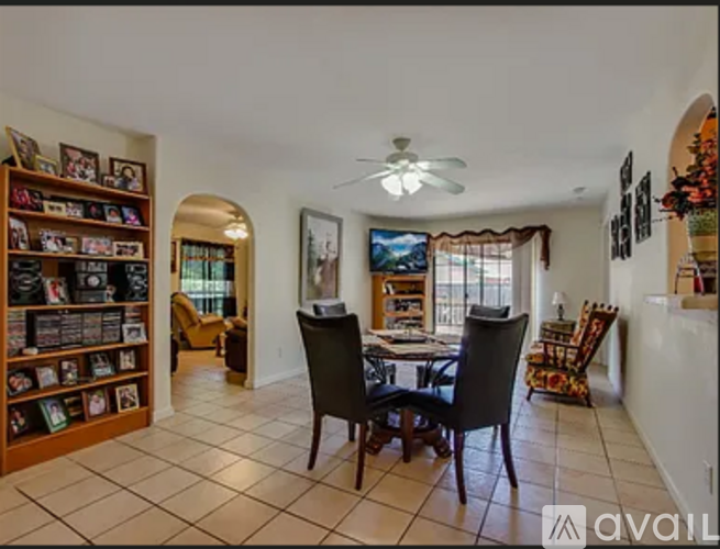 A living room with a dining table and chairs.