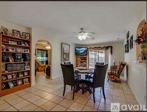 A living room with a dining table and chairs.