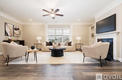A living room with a fireplace and a television on the wall.