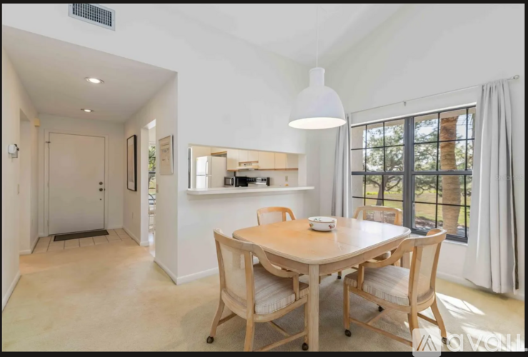 A dining room with a wooden table and chairs.