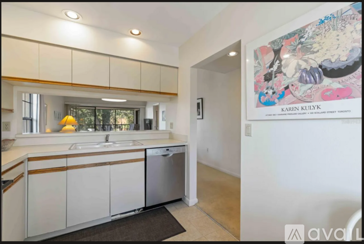 A kitchen with white cabinets and a sink.