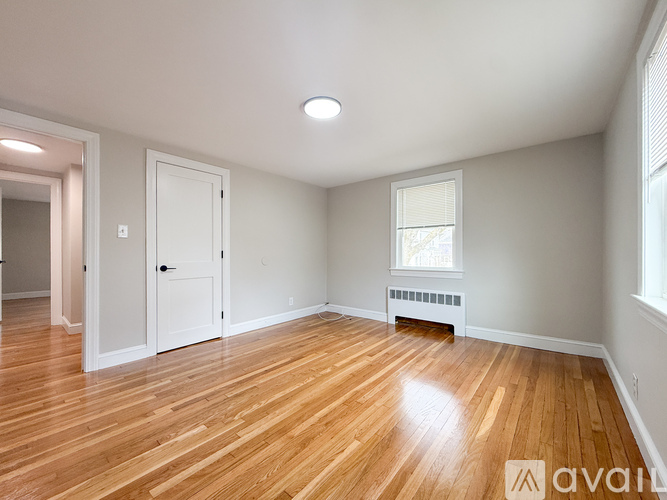 A room with wooden floors and white walls.