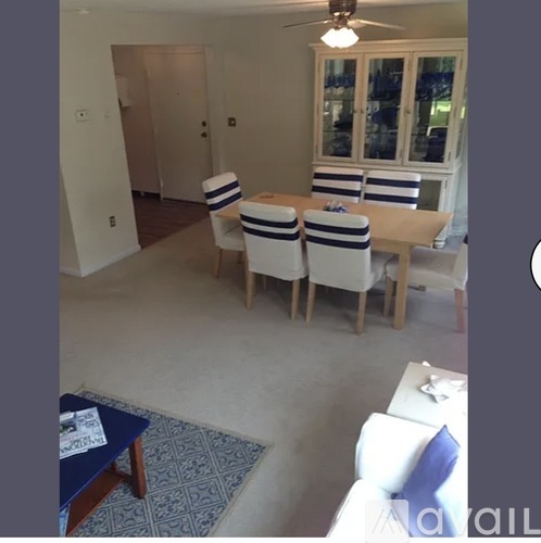 A dining room with a table and chairs.