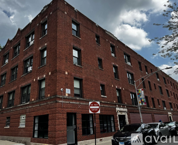 A red brick building with a "Do Not Enter" sign in front.