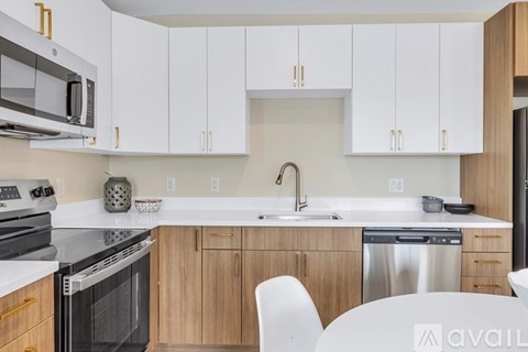 A kitchen with white cabinets and a stainless steel dishwasher.