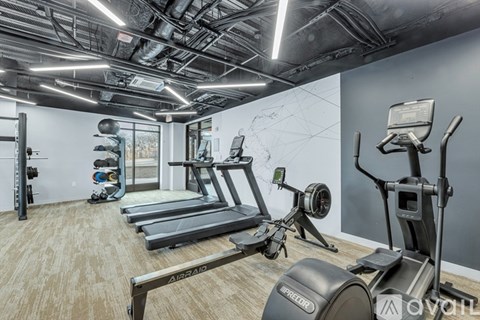A gym with treadmills, elliptical machines, and other exercise equipment.