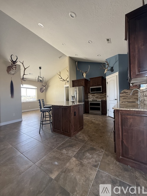 A kitchen with a bar and a chair.