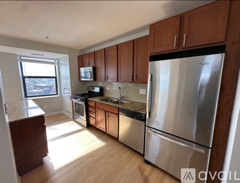 A kitchen with wooden cabinets and stainless steel appliances.