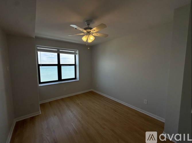 A room with a ceiling fan and a window.