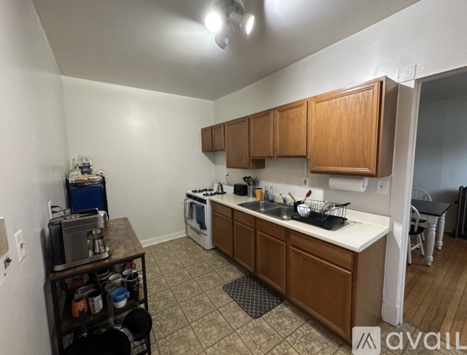 A kitchen with wooden cabinets and a white countertop.