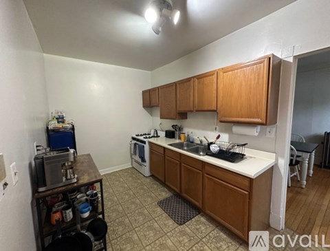 A kitchen with wooden cabinets and a white countertop.