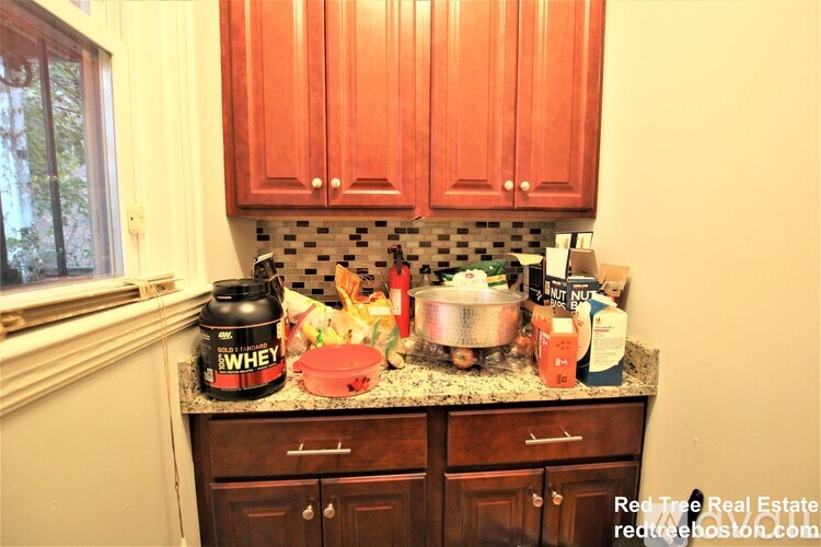 A kitchen counter with a can of whey on it.