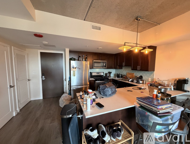 A kitchen with dark wood floors and a stainless steel oven.