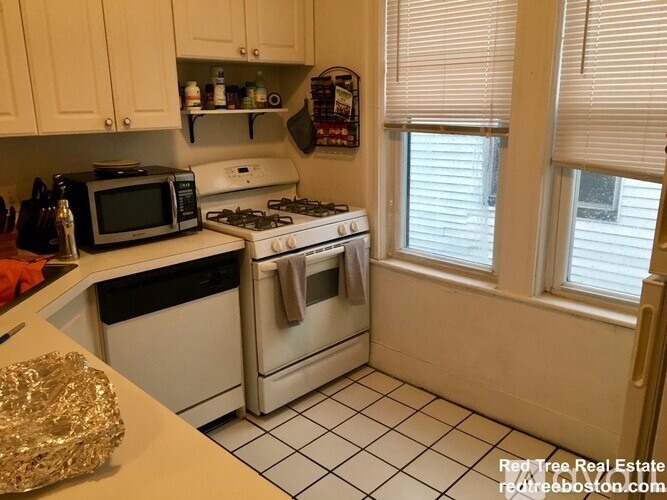 A kitchen with a stove top oven and microwave.