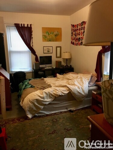 A bedroom with a bed in the middle of the room.