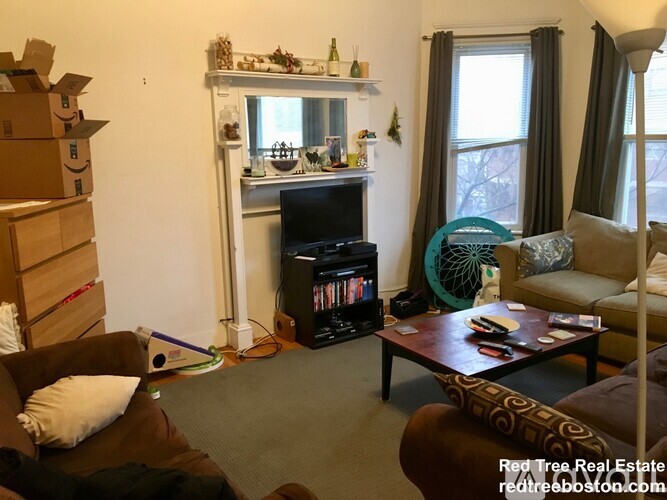 A living room with a fireplace and a couch.