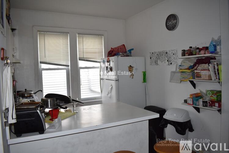 A kitchen with a white fridge and a white counter top.