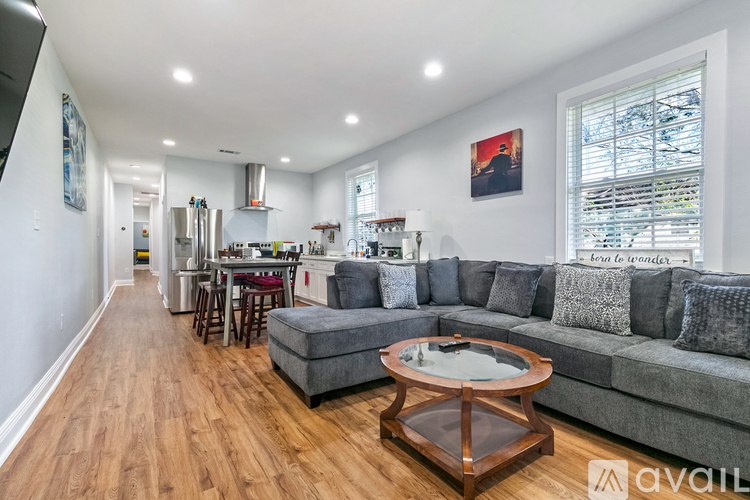 A modern living room with a grey sofa and a wooden coffee table.