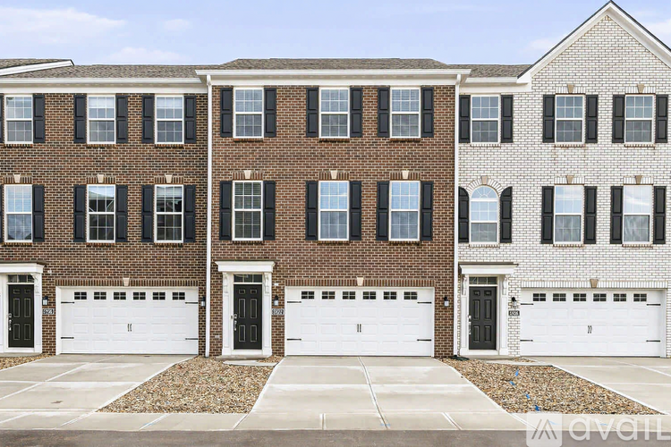 A row of townhouses with garages in front.