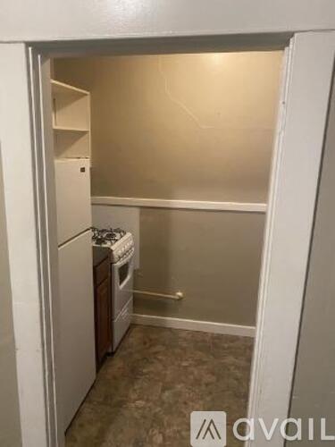 A small kitchen with a dishwasher and a refrigerator.