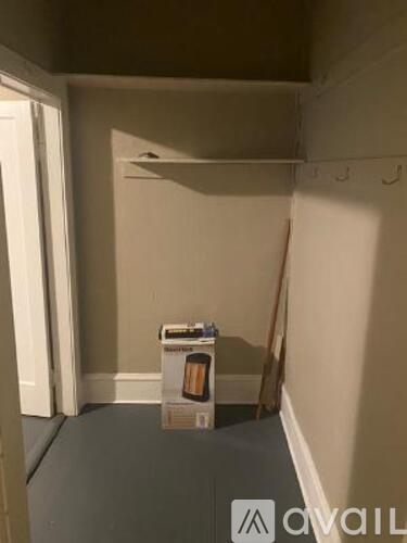 A small box of tissues is on the floor of a room.