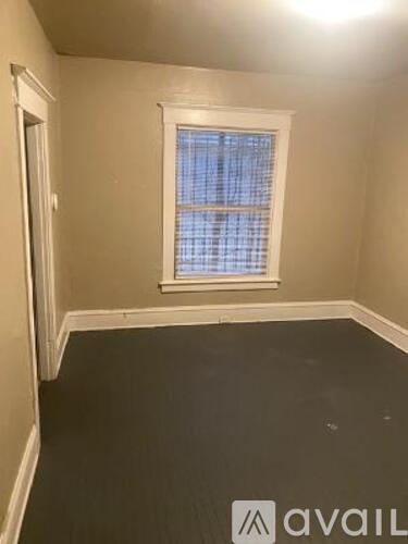 A room with a window and a wall with a logo on it.
