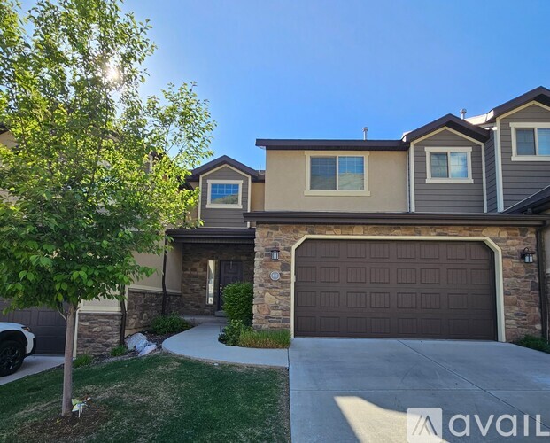 A house with a brown garage door is for sale.