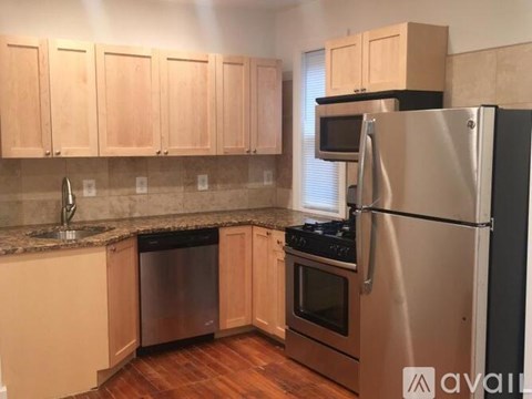 A kitchen with wooden cabinets and stainless steel appliances.