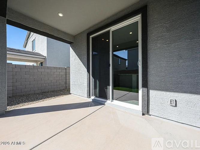 A modern house entrance with a glass door and a concrete wall.