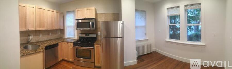 A kitchen with wooden cabinets and stainless steel appliances.