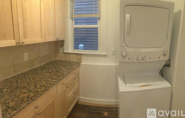 A small laundry room with a washer and dryer.
