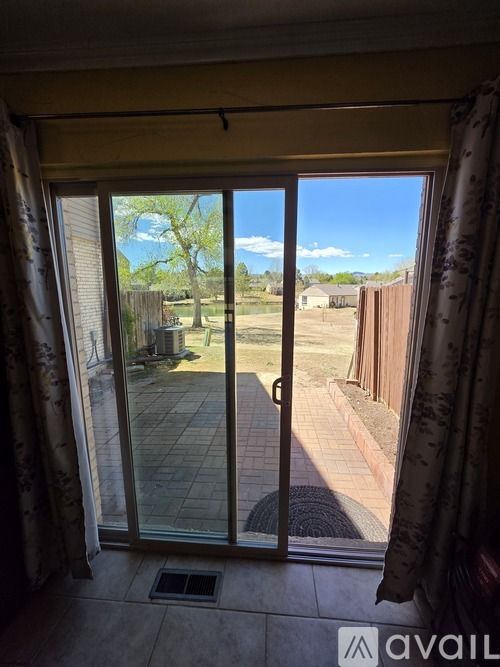 A view from inside a room looking out through a sliding glass door.
