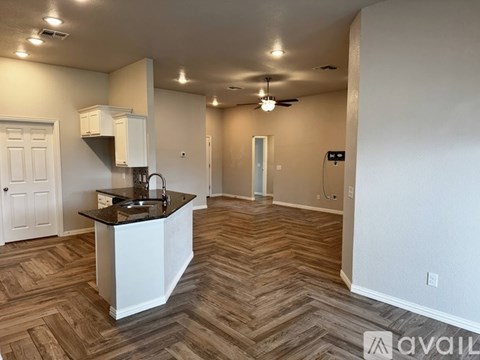 A kitchen area with a sink and a countertop.