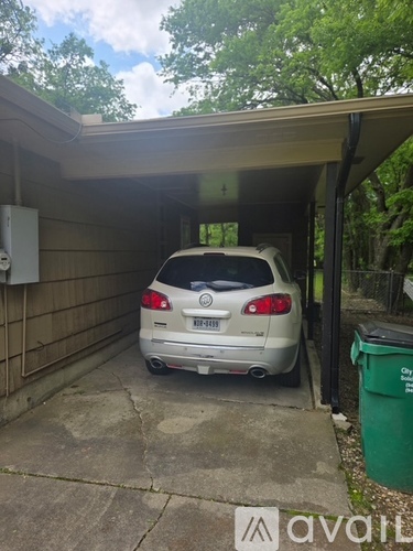 A silver car is parked in a garage.