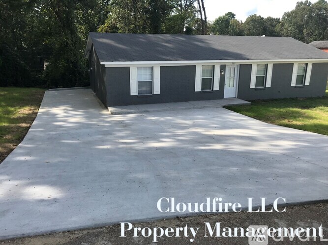 A house with a driveway in front and Cloudfire LLC Property Management written on it.