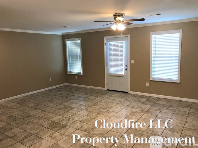 A room with a tile floor and a ceiling fan, with the text "Cloudfire LLC Property Management" overlaid on the image.