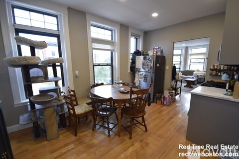 A kitchen with a table and chairs in the middle of the room.