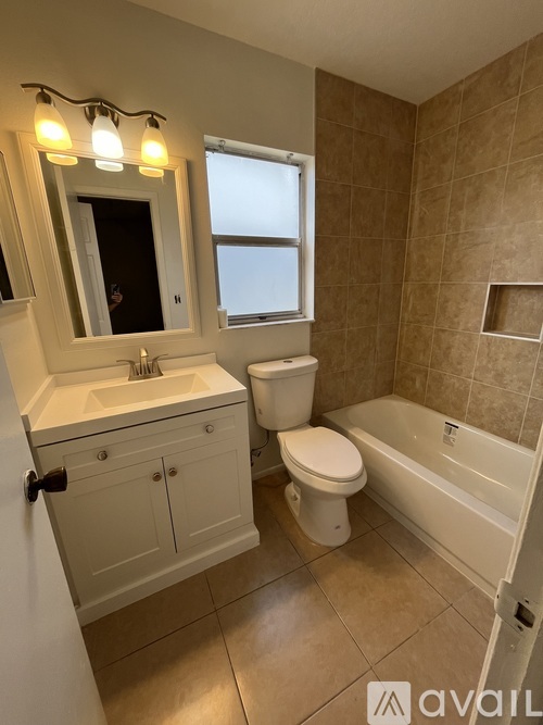 A bathroom with a toilet, sink, and bathtub.