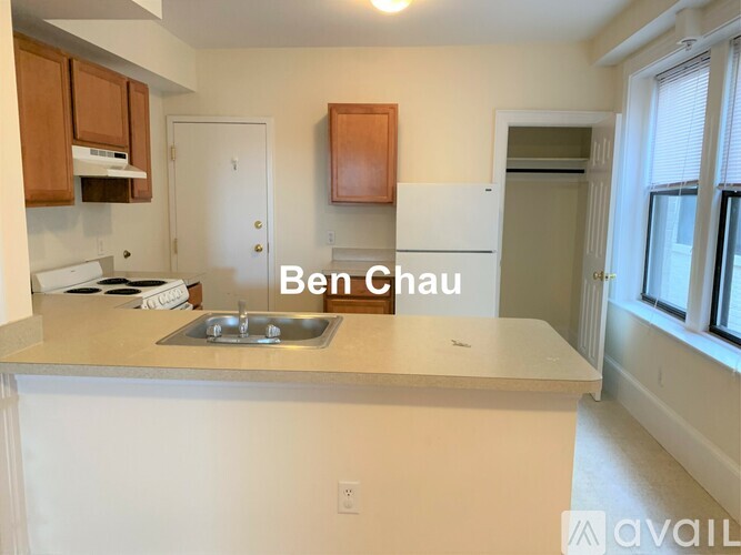 A kitchen with a white countertop and a sink.