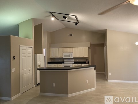 A kitchen with a counter and cabinets is available for rent.