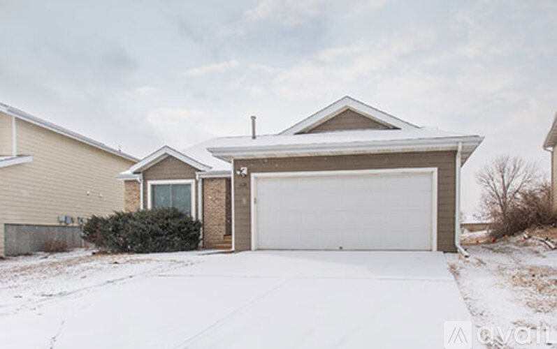 A house with a garage door is in front of a house.