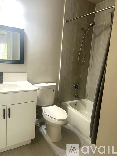 A bathroom with a toilet, sink, and bathtub.