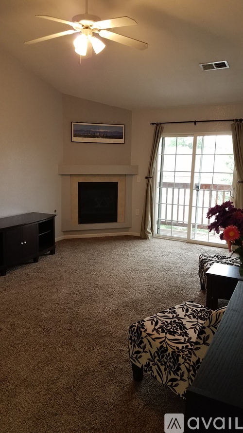 A living room with a fireplace and a painting on the wall.