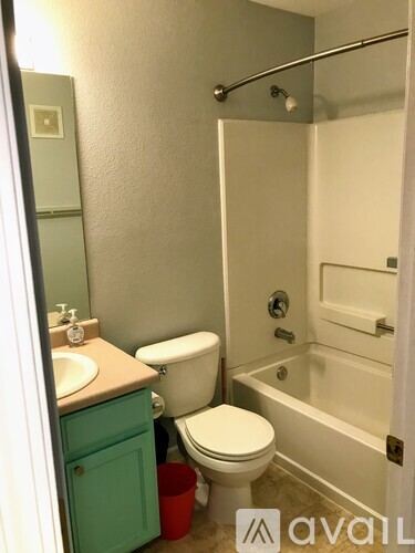 A bathroom with a toilet, sink, and bathtub.