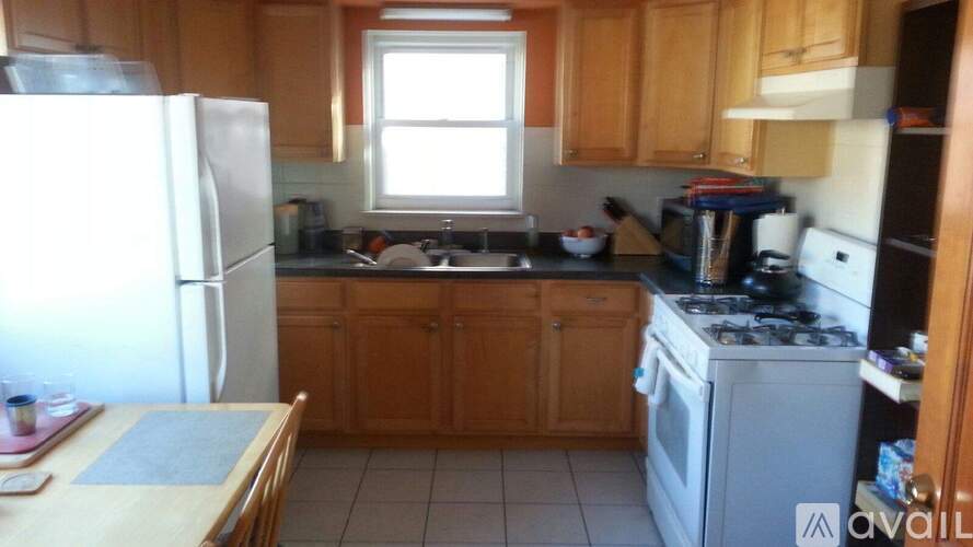 A kitchen with wooden cabinets and a white refrigerator.