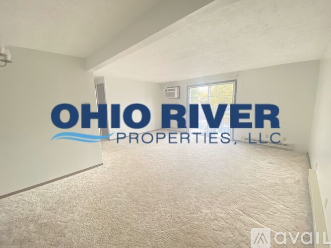 A room with a carpet floor and a wall with the text "Ohio River Properties, LLC" written on it.