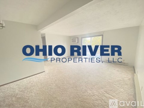 A room with a carpet floor and a wall with the text "Ohio River Properties, LLC" written on it.