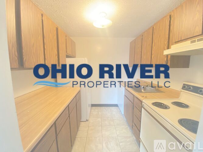 A kitchen with wooden cabinets and a logo that reads "Ohio River Properties LLC".