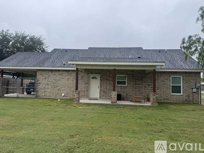 A house with a grey roof and a white door is available for purchase.